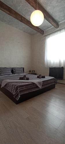 a large bed in a room with a large window at Bellevue Beam House in Covasna