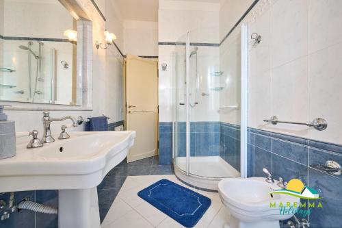 a bathroom with a sink and a toilet and a shower at Maremma Holidays Zot's Penthouse in Follonica