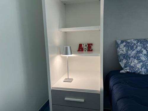 a bedroom with a bed and a nightstand with a lamp at Casa Vacanza IMPARO B&B Ischia in Ischia