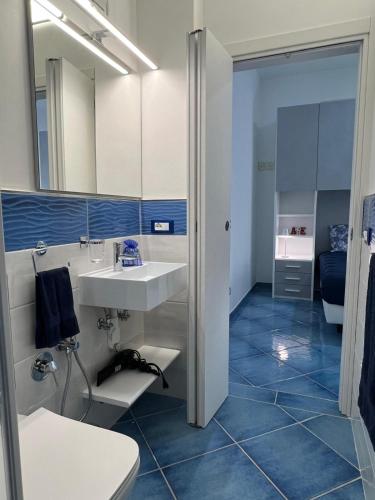 a bathroom with a white sink and a toilet at Casa Vacanza IMPARO B&B Ischia in Ischia