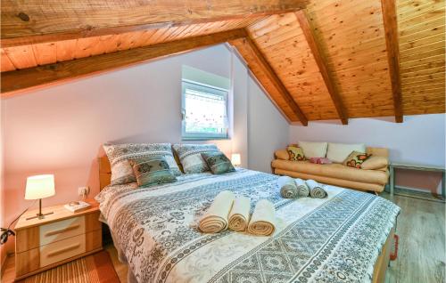 a bedroom with a bed with shoes on it at Amazing Home In Susobreg With Wifi in Jertovec