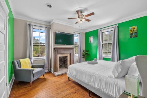 a green bedroom with a bed and a fireplace at Half Off SALE! Downtown Home with King Bed FirePit Free Parking and Huge Back Yard Filming Allowed in Wilmington