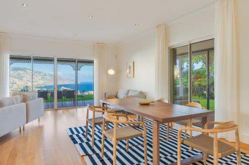 a dining room with a table and chairs at Sublime View Villa by Atlantic Holiday in Funchal