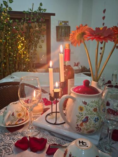 a table with a tea set with candles and flowers at Hotel Villa Teresita in Sáchica