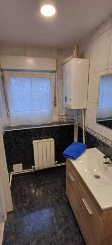 ein kleines Badezimmer mit Waschbecken und Fenster in der Unterkunft Duplex Acogedor en Areatza, cerca del Parque Gorbea in Areatza