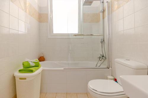 a bathroom with a tub and a toilet and a sink at Villa Fedrita in Acharavi