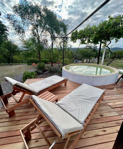 a deck with two lounge chairs and a pool at El Satélite in Cordoba