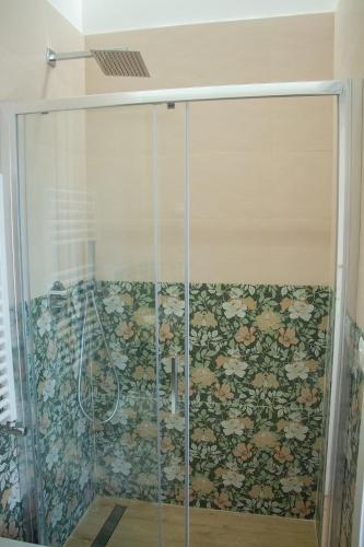 a shower in a bathroom with a floral wallpaper at WANDERLUST SPACCANAPOLI Points Of View in Naples