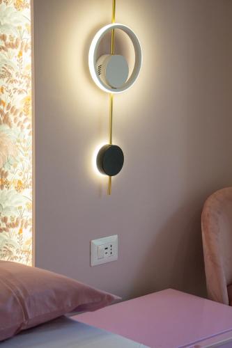 a mirror hanging on a wall next to a bed at WANDERLUST SPACCANAPOLI Points Of View in Naples