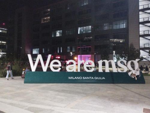 a sign that says we are awesome in front of a building at Santa Giulia Terrace - 15 Mins City Center in Linate