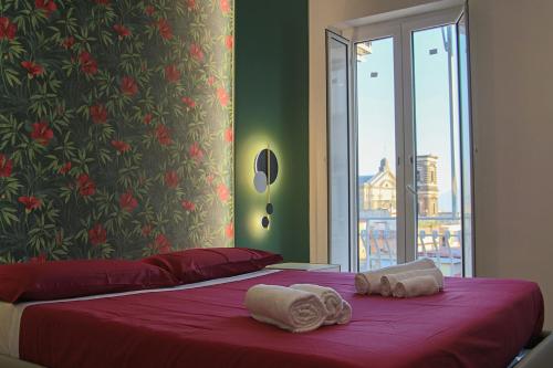 a bedroom with two beds with towels on them at WANDERLUST SPACCANAPOLI Points Of View in Naples
