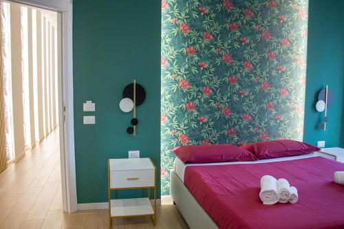 a bedroom with a purple bed with a floral wall at WANDERLUST SPACCANAPOLI Points Of View in Naples