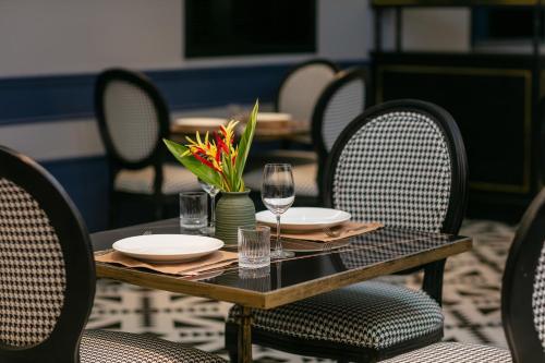 a table with plates and wine glasses on it at Phat Diem Plaza Hotel in Ninh Binh