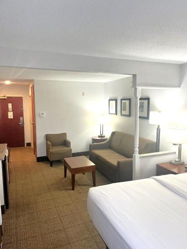 a hotel room with a bed and a couch at Comfort Inn & Suites in Jackson