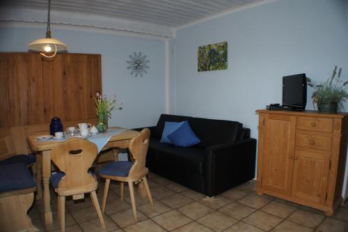 a living room with a table and a couch at Bio-Erlebnisbauernhof Doll in Nittenau