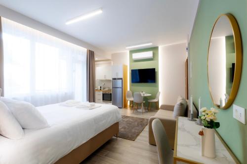 a bedroom with a large white bed and a mirror at CityLuxe Center Ioannina in Ioannina