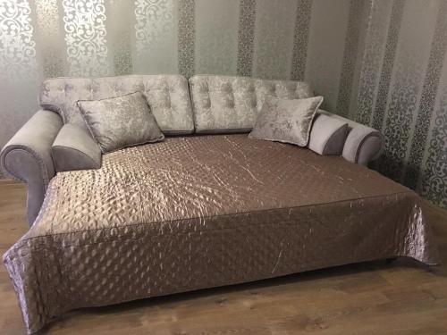 a bed in a room with a large bed with pillows at Apartment On Knyagini Olga Street in Lviv