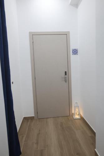 a door in a room with a light on the floor at B&B AnMa in Ercolano