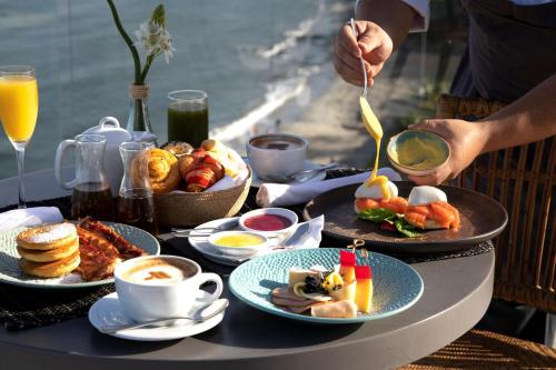 a table full of breakfast foods and coffee on the beach at Santa Marta Marriott Resort Playa Dormida in Santa Marta