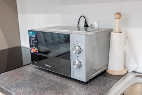 a microwave sitting on top of a counter at GOLDEN OASIS Free Private Parking in Ljubljana