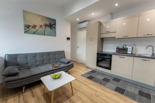 a living room with a couch and a kitchen at GOLDEN OASIS Free Private Parking in Ljubljana