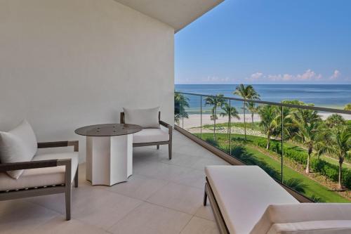 a balcony with a table and chairs and the ocean at The St. Regis Longboat Key Resort in Longboat Key