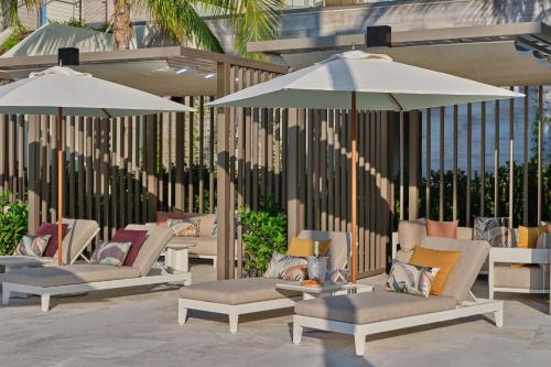 a group of chairs and umbrellas on a patio at The St. Regis Longboat Key Resort in Longboat Key