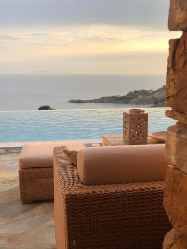 a view of the ocean from a spa with a tub at Luxury Cycladic Villa-Enjoy Infinity Pool Sunsets in Koundouros