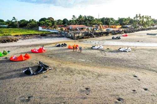 a group of people standing on a beach with tents at Panama Kite House - Kite, Eat, Sleep, Repeat in Punta Chame