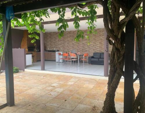 a patio with orange chairs and a table at Carlos Nogueira in Parnaíba