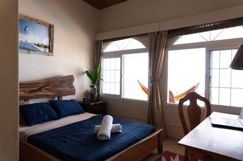 a bedroom with a bed with two white towels on it at Panama Kite House - Kite, Eat, Sleep, Repeat in Punta Chame