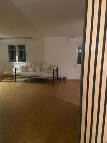 a living room with a white couch in a room at Im grünen aber in 20min in Basel in Ettingen