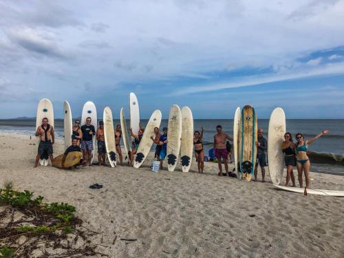 a group of people standing in front of their surfboards at Panama Kite House - Kite, Eat, Sleep, Repeat in Punta Chame