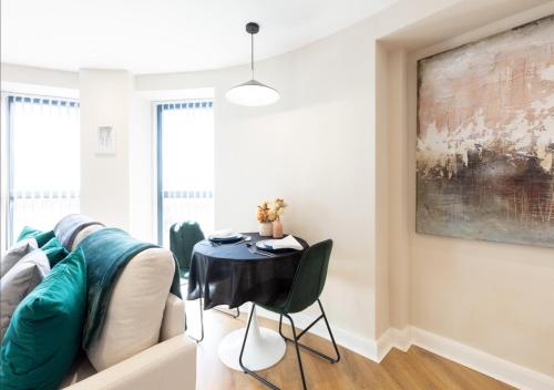 a living room with a table and a couch at Stylish Central Leeds Arena Apartment Free Parking in Leeds