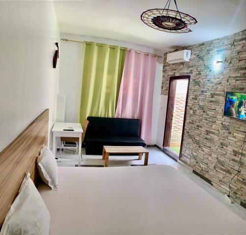 a living room with a bed and a couch at Maison Toutaf in Dakar