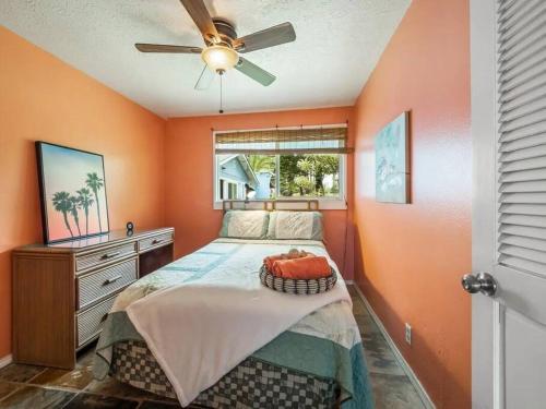 a bedroom with a bed and a ceiling fan at Ocean Front Paradise with Hot Tub in Hawaii in Keaau