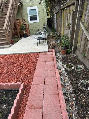 a patio with a table and chairs in a yard at Bumblebee House in Oakland