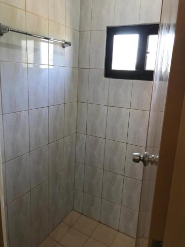 a bathroom with a shower with a window at Seaside Beach Resort in San Fabian