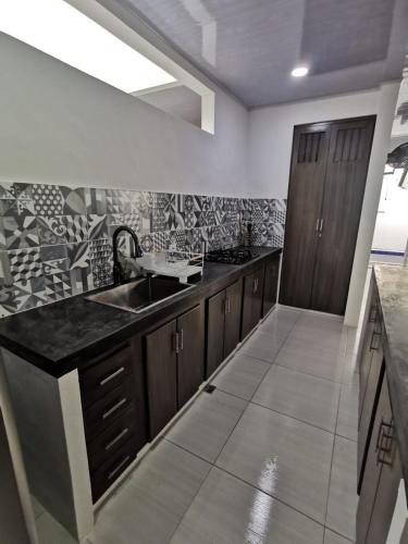 a kitchen with a sink and a counter top at Casa Floralia in Honda