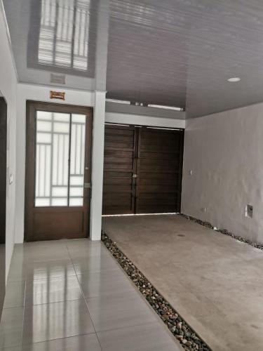 an empty room with two doors and a floor at Casa Floralia in Honda