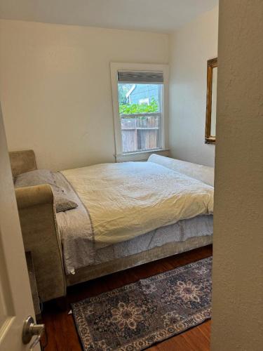 a bedroom with a bed and a window at Bumblebee House in Oakland