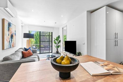 a living room with a table with pears on it at Barkly Beachside Escape in Melbourne