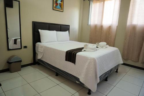 a bedroom with a bed with two towels on it at Posada Rabin Ajaw in San Juan La Laguna