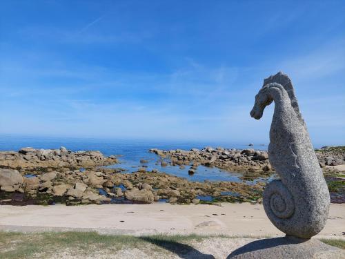 a statue of a seahorse on the beach at Holiday Home in Brittany with Sea View in Cléder