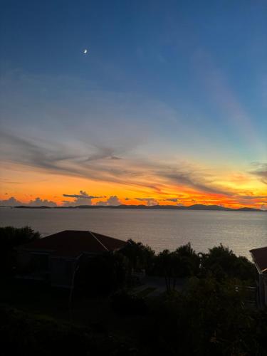 a sunset over a body of water at Ocean View Villas in Jost Van Dyke