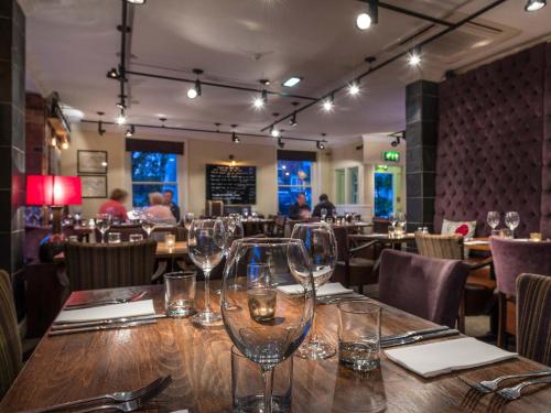 a table in a restaurant with wine glasses on it at The White Hart Hotel, Boston, Lincolnshire - The Coaching Inn Group in Boston