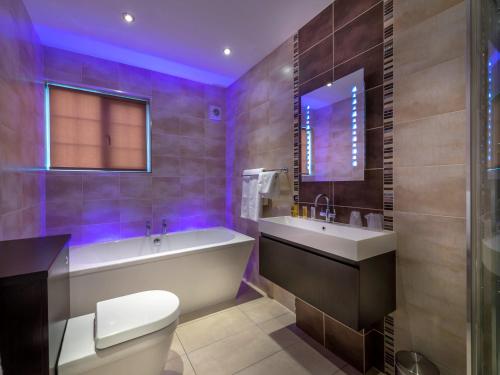 a bathroom with a tub and a toilet and a sink at The White Hart Hotel, Boston, Lincolnshire in Boston