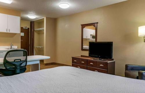a hotel room with a bed and a television at Extended Stay America Suites - Detroit - Ann Arbor - Briarwood Mall in Ann Arbor