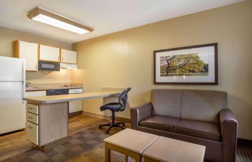 a small office with a desk and a couch and a chair at Extended Stay America Suites - Charleston - Airport in Charleston