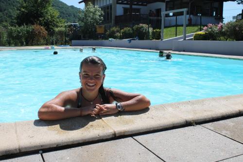 a woman laying in a swimming pool at Narbaitz Vacances in Saint-Jean-Pied-de-Port